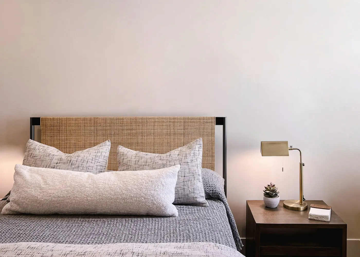 A brass lamp on a wooden bedside table